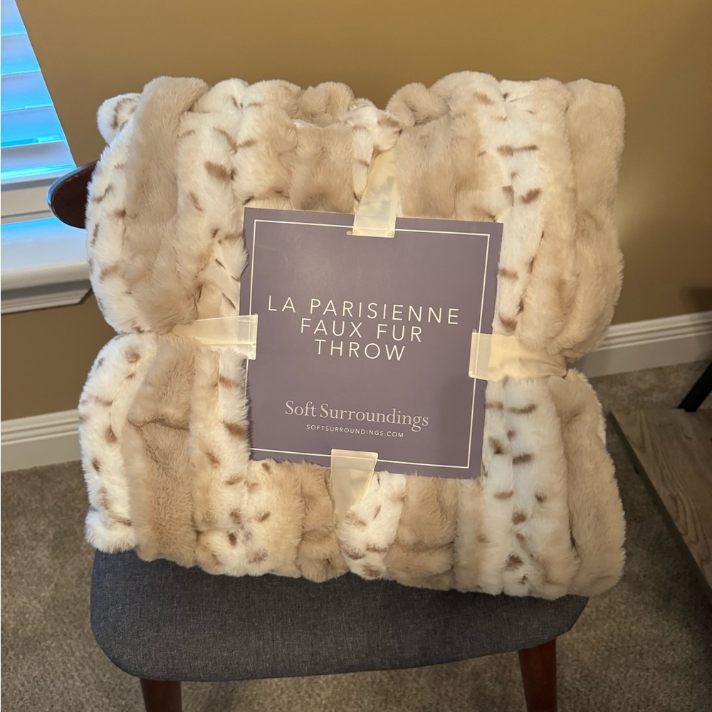 Soft surrounding faux fur throw